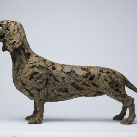 Bronze, textured sculpture of a dachshund by Joseph Paxton titled How to Win Friends and Influence People.